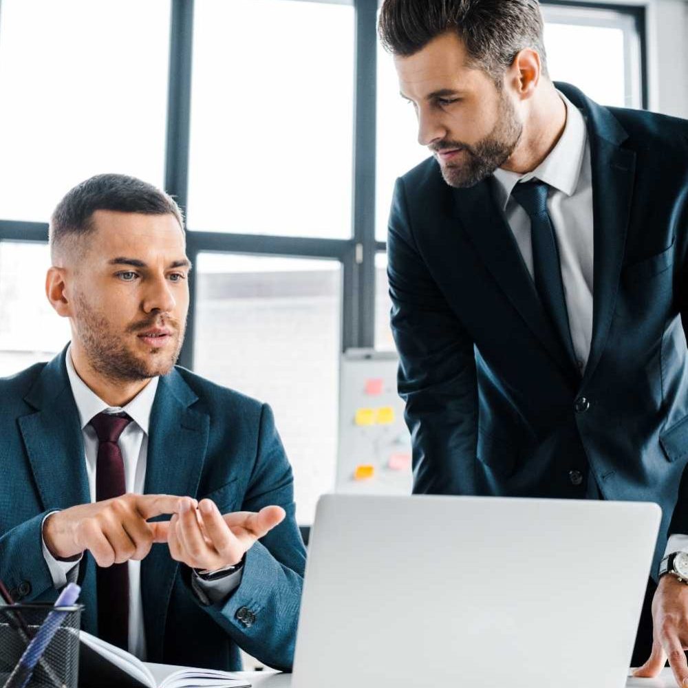 handsome-businessman-talking-with-coworker-in-mode-D8NL5LJ-qr8f1ay76cf96vots2qzbmezo7s0s5dbvbgxp8xiow